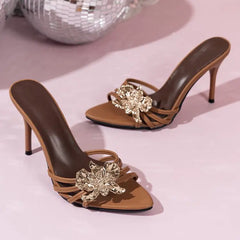Brown stiletto heels with gold floral embellishment