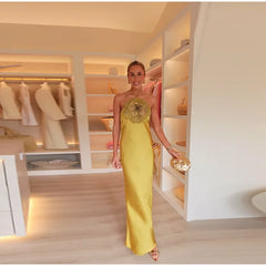 Woman in a yellow dress standing in a well-lit closet.