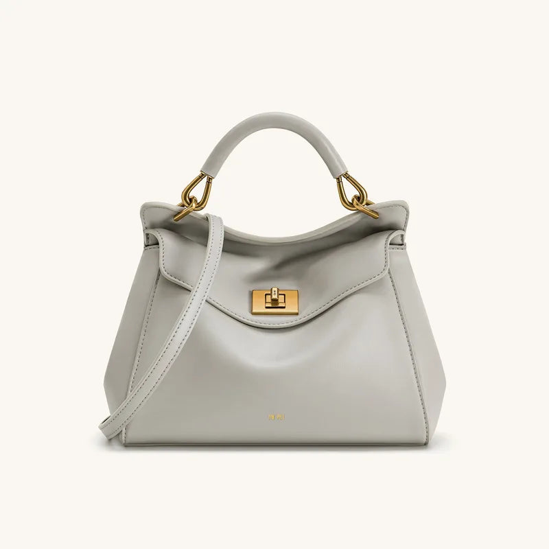 Light grey smooth leather top handle bag with gold hardware.