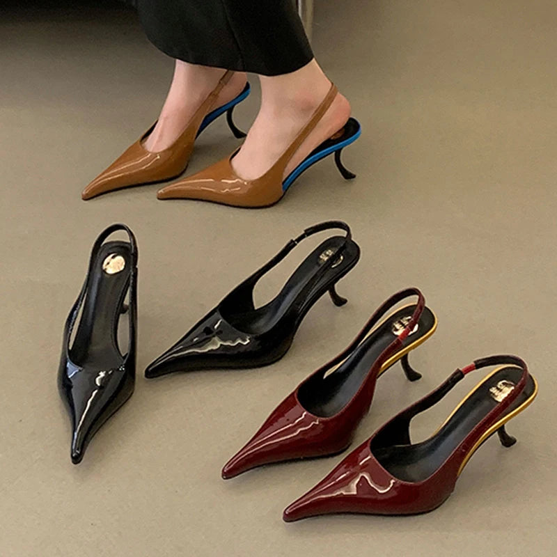 Set of heeled shoes in black, brown, and red on a neutral background