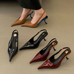 Set of heeled shoes in black, brown, and red on a neutral background