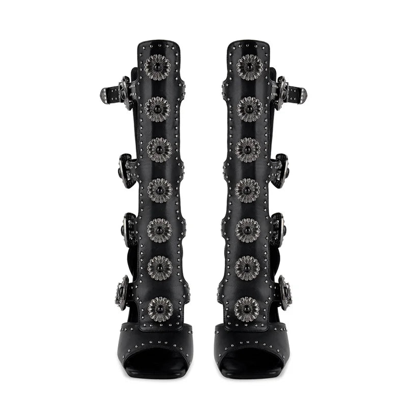 Gladiator stiletto heel sandals, black leather, front view with floral embellishments