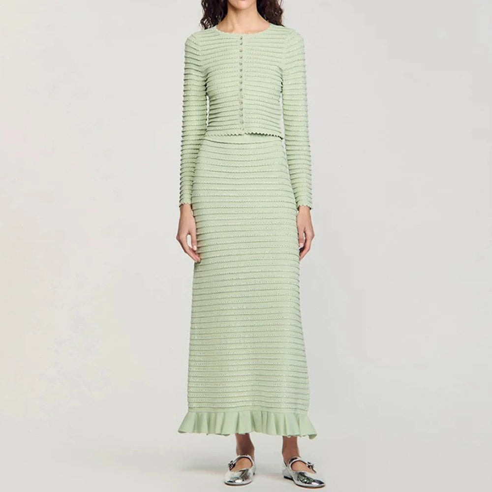 Light green knit cardigan and midi skirt set worn by a model.