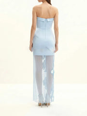 Back view of light blue floral print strapless maxi dress with sheer overlay