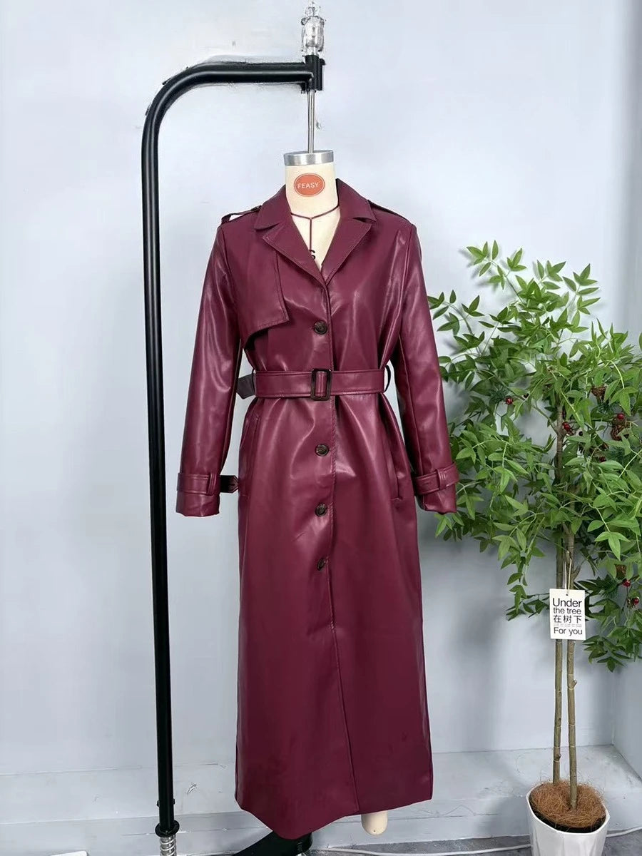 Burgundy faux leather trench coat on display
