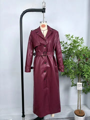 Burgundy faux leather trench coat on display