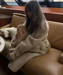 Woman sitting on a couch in a luxurious interior setting