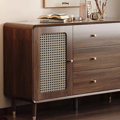 Rattan-panel cabinet used as entryway console with decorative accents

