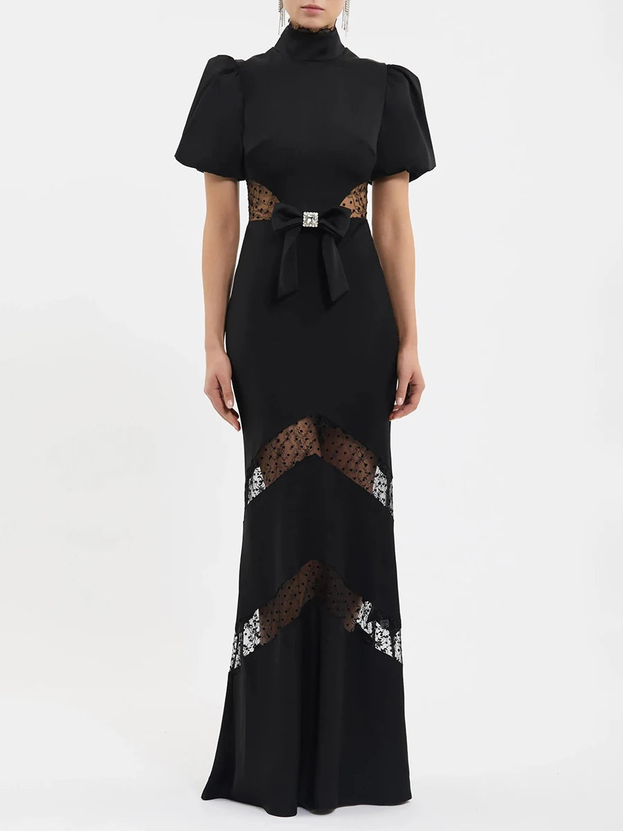 Back view of black puff sleeve maxi dress with mock neck and lace details