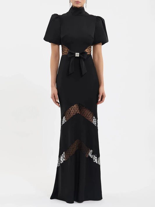 Back view of black puff sleeve maxi dress with mock neck and lace details