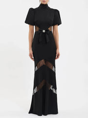 Back view of black puff sleeve maxi dress with mock neck and lace details