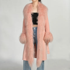 Person wearing a pink fluffy coat with a plain background