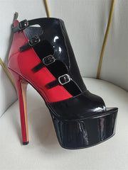 Close-up of a peep toe platform ankle boot with red and black patent leather and buckle details