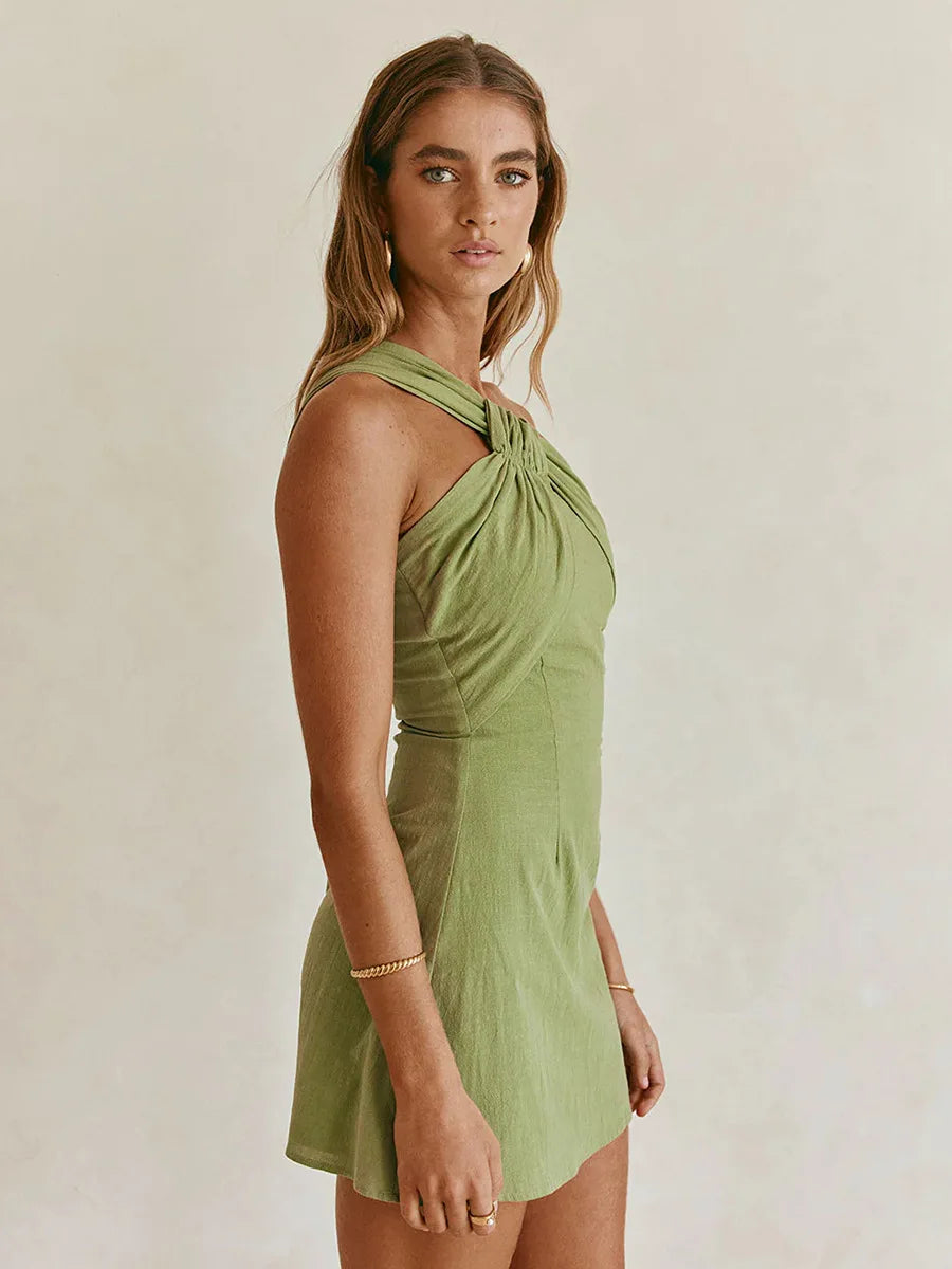 Woman wearing a green dress against a plain background