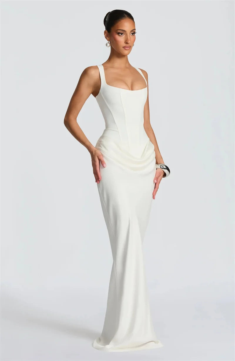 Woman wearing a white evening gown on a plain background