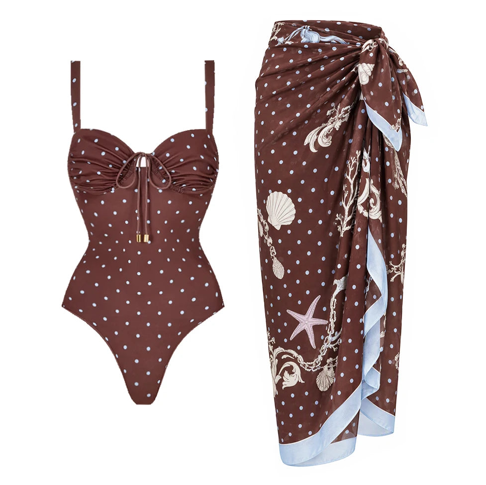 One-piece polka dot swimwear with adjustable straps and tie detail, paired with a coordinating polka dot skirt with seashell print.