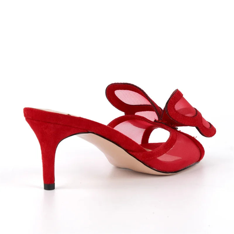 Close-up side view of red kitten heel mesh bow sandals