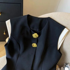 Black vest with gold buttons on a chair