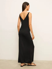 Woman wearing a black sleeveless dress against a white background