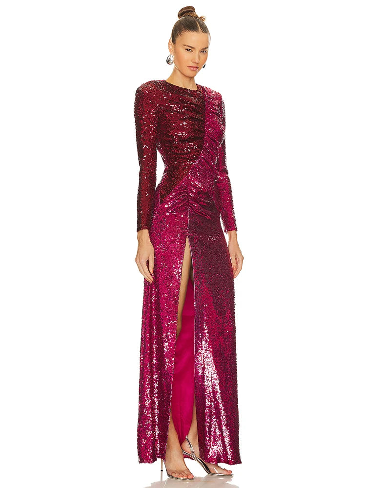 Woman wearing a long, sparkly burgundy dress with a high slit on a white background
