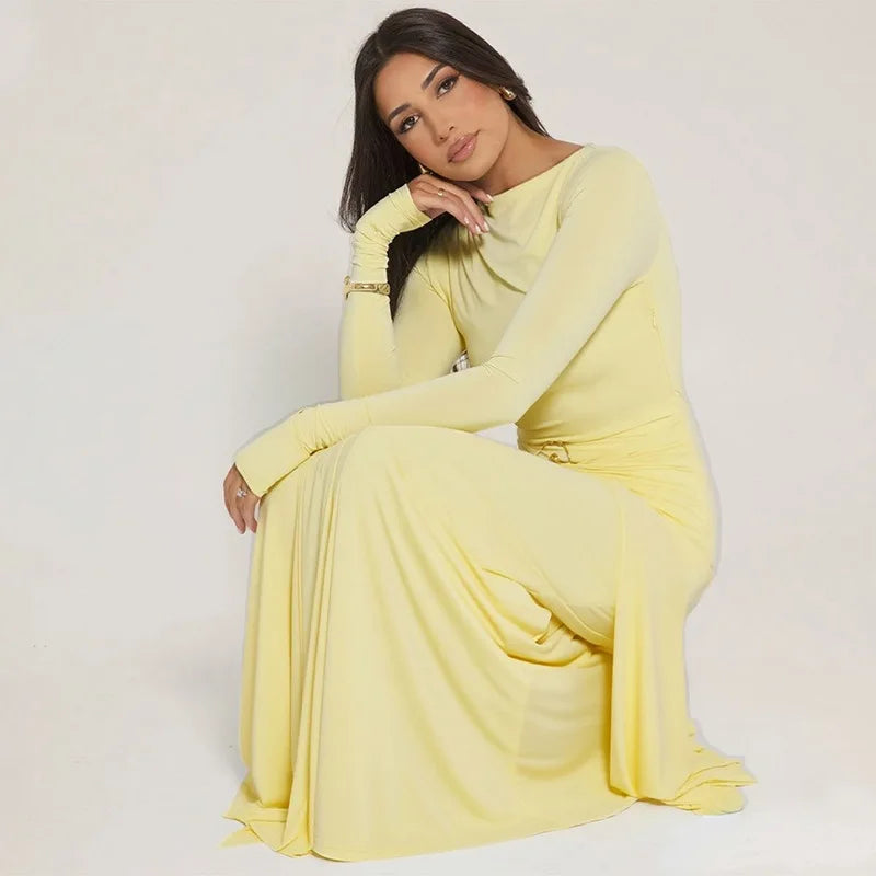 Woman in a yellow dress sitting on a white background