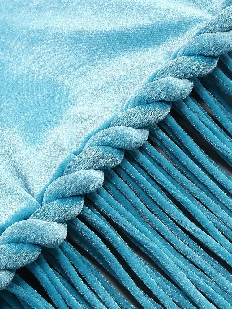 Close-up of a blue textured fabric with braided edge