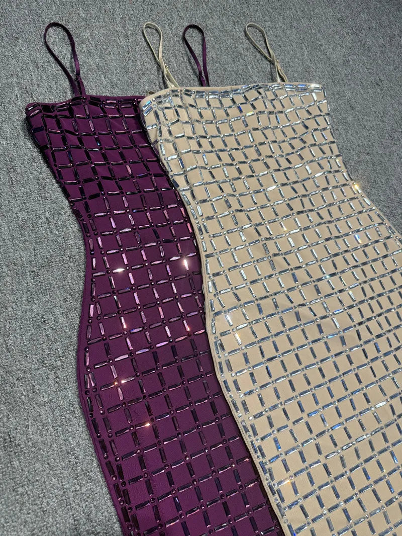 Two sequined dresses, one purple and one beige, on a gray surface.
