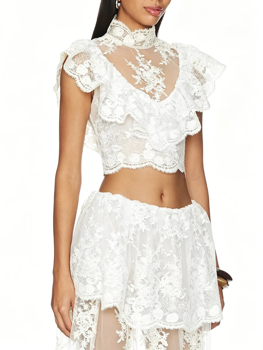 Close-up of white floral lace high neck sleeveless crop top