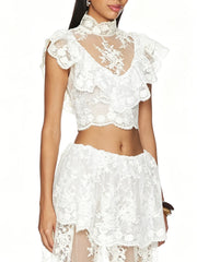 Close-up of white floral lace high neck sleeveless crop top