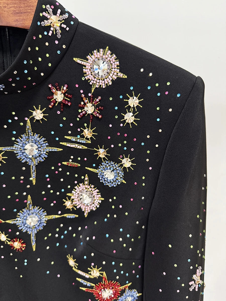 Black garment with colorful star-shaped embellishments on a white background