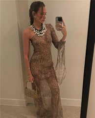 Woman taking a mirror selfie wearing a leopard print dress with a sheer overlay.