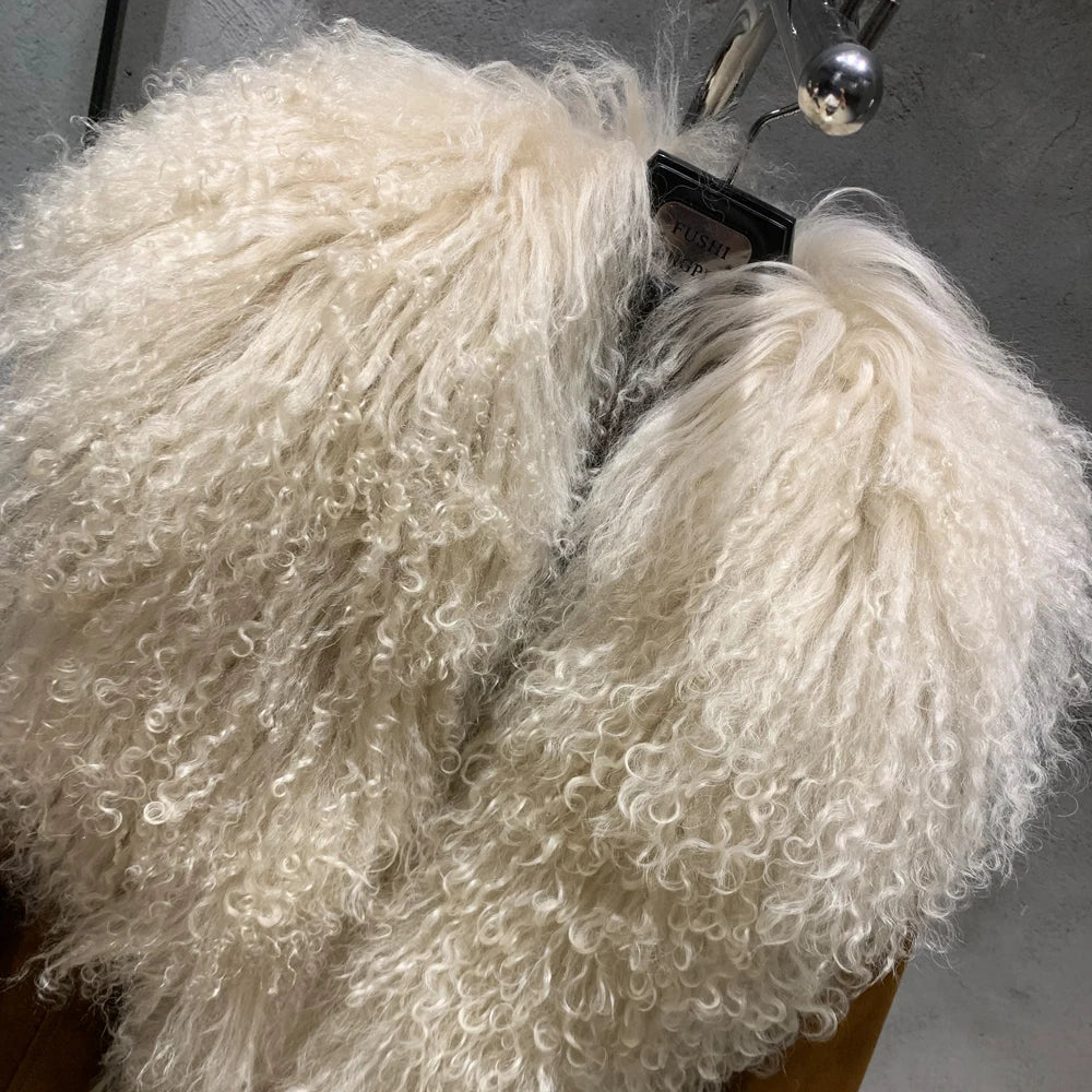 White fluffy scarf on a hanger against a gray background