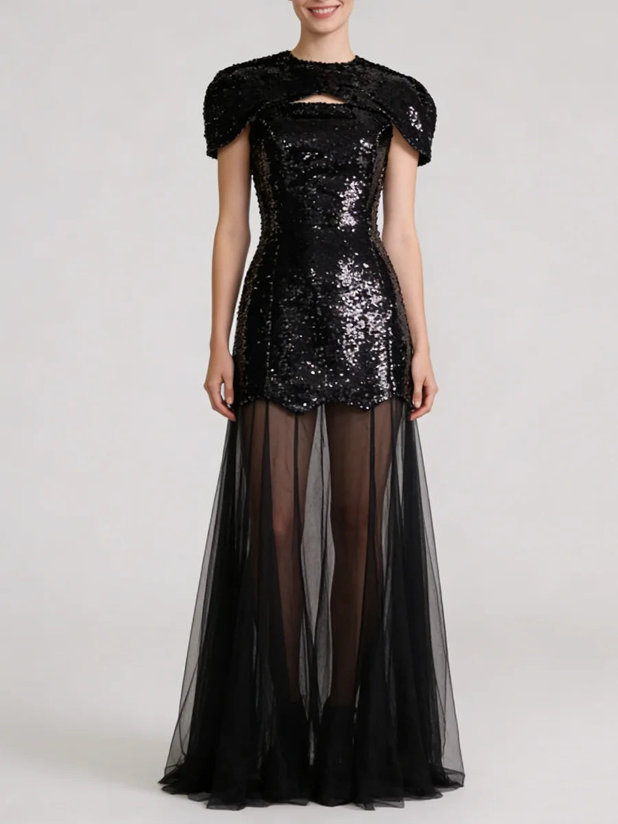Black sequin mini dress with sheer tulle maxi overlay, featuring cap sleeves and a décolletage cut-out.