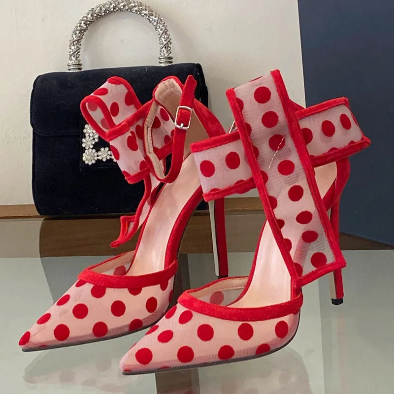 Polka dot mesh stiletto heels styled with a black handbag