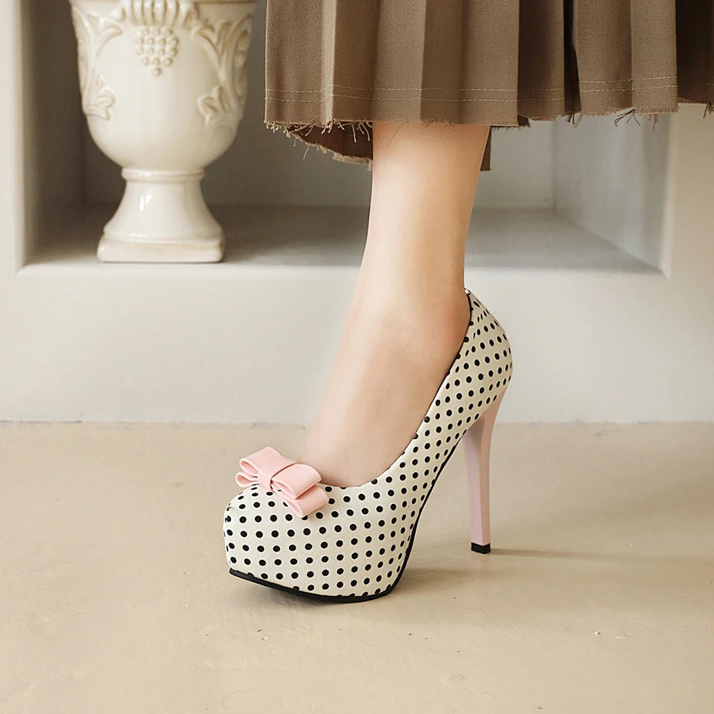 Close-up of white polka dot bow platform heel