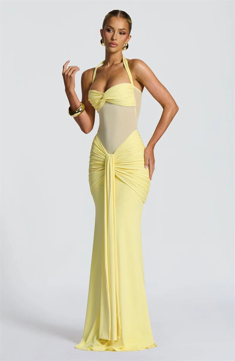 Woman wearing a yellow evening gown on a light gray background