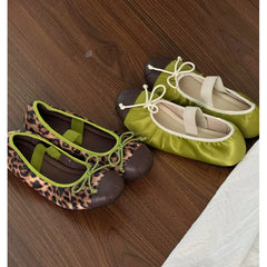 Leopard print ballet flats with brown toe cap and green trim