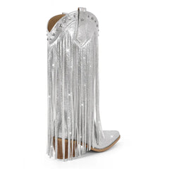 Silver studded and fringed cowboy boot on a white background