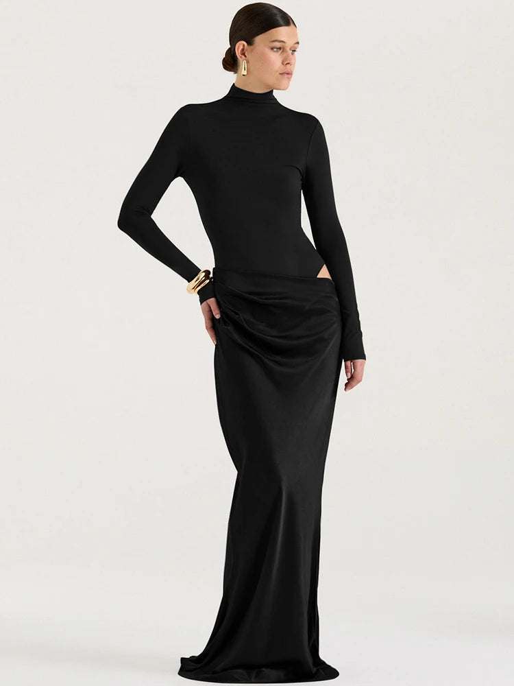 Woman wearing a black long-sleeve top and black pencil skirt on a white background