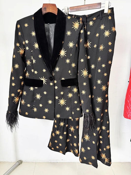 Black star embroidered blazer and flare pants set hanging on a rack.