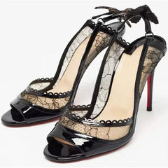 Close-up of black lace stiletto heel with peep toe and butterfly detail