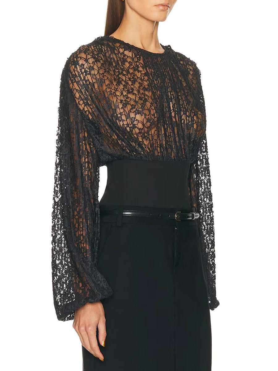 Black lace long-sleeve top worn by a model on a white background