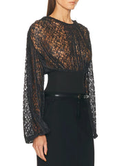 Black lace long-sleeve top worn by a model on a white background