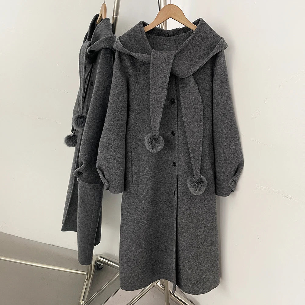 Hooded wool blend coat in grey with a detachable pom-pom scarf.