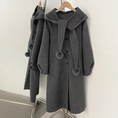 Hooded wool blend coat in grey with a detachable pom-pom scarf.