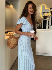 Model wearing a light blue ruffled knit maxi dress.