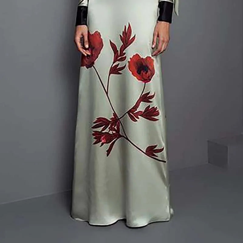 Long white dress with red floral patterns on a gray background