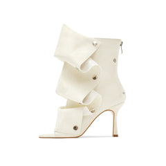 Peep toe stiletto heel boots in off-white with ruffled overlay.