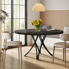 Dining room with a black round table, chairs, and a vase of sunflowers.