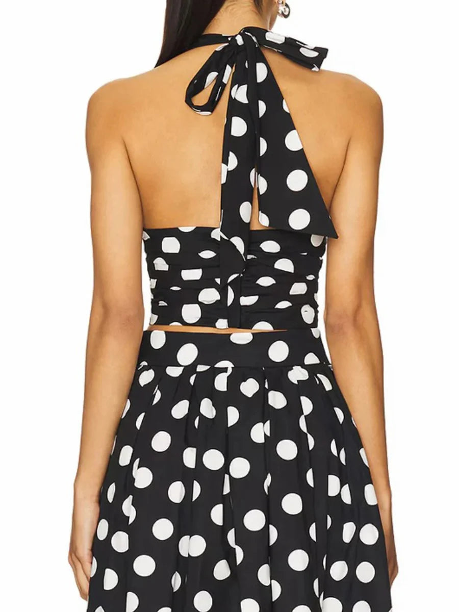 Sleeveless halter crop top with matching polka dot A-line skirt.